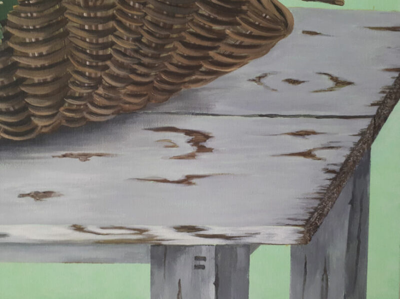 Close up of painting of basket on vintage table